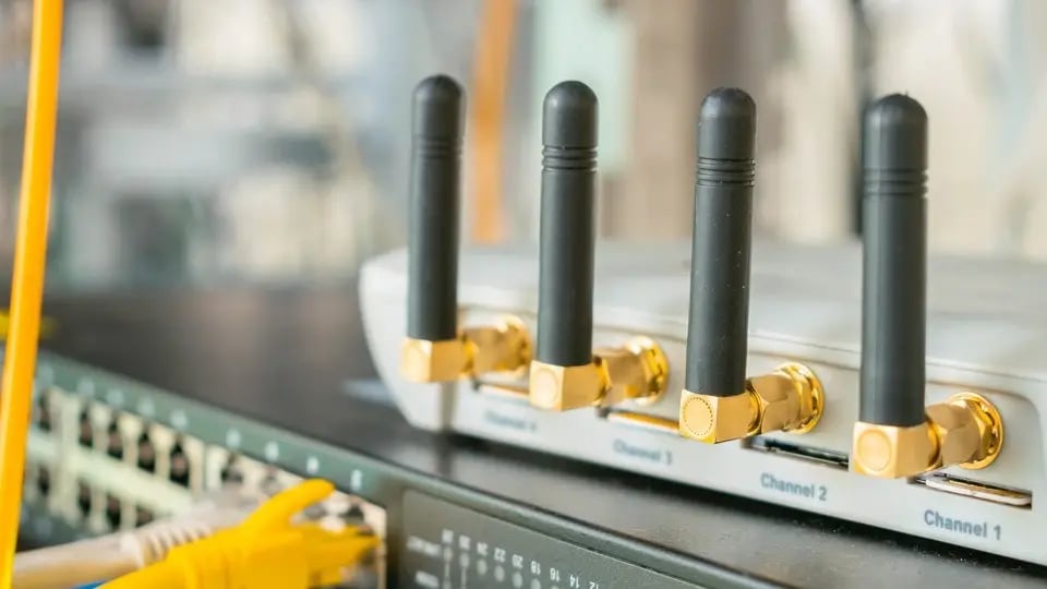 Technicians monitoring WiFi network in a modern operations center.