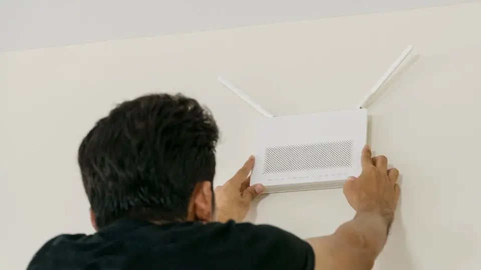 Technician installing WiFi access point