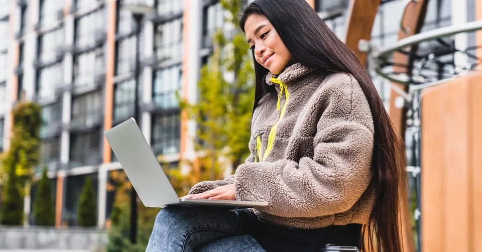 woman-using-laptop-building-outdoors